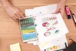 Margin Of Safety Ratio: A Guide To Calculate It With The Formula 4 Person Holding White Samsung Galaxy Tab