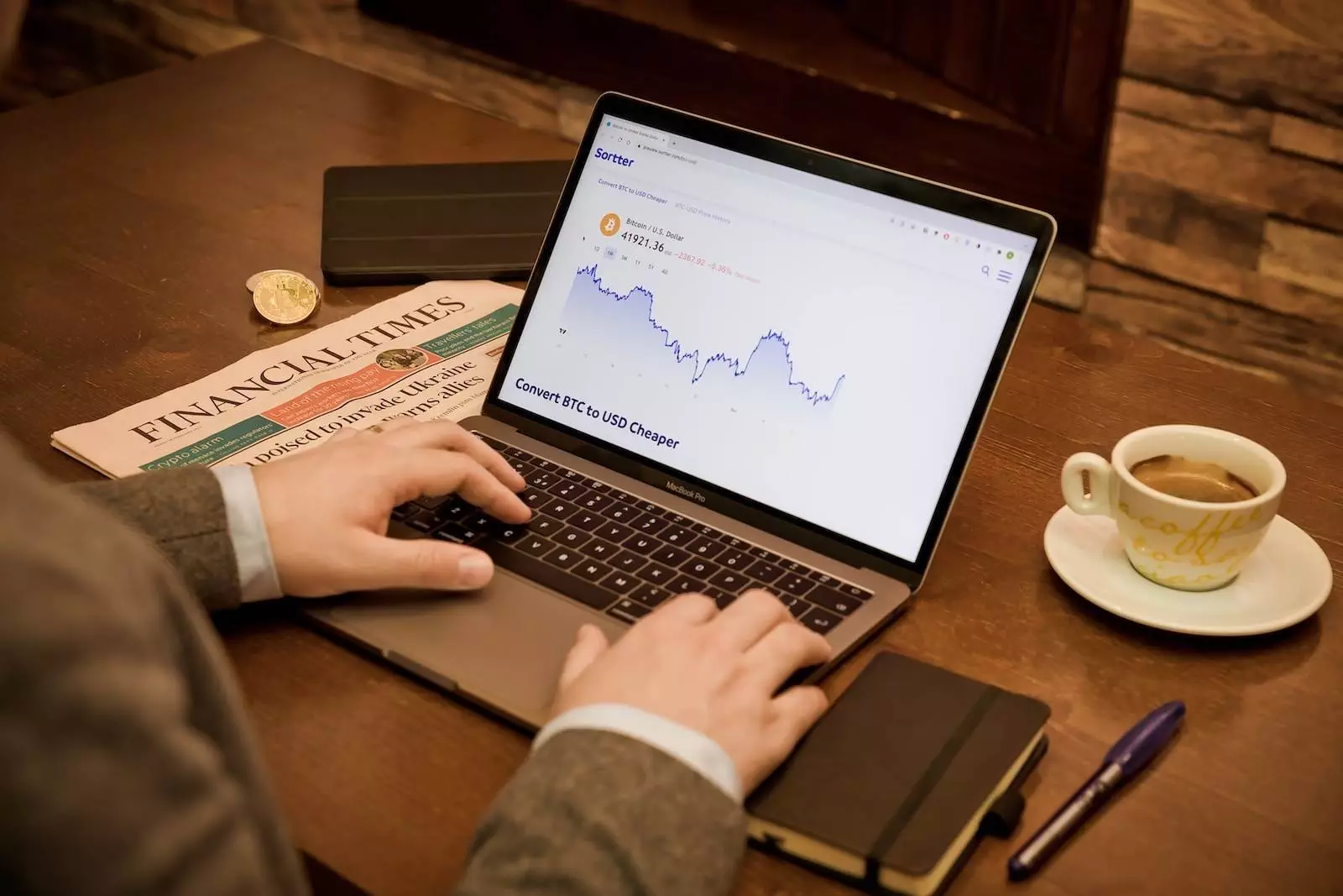 a person typing on a laptop on a table - Blue-chip stocks