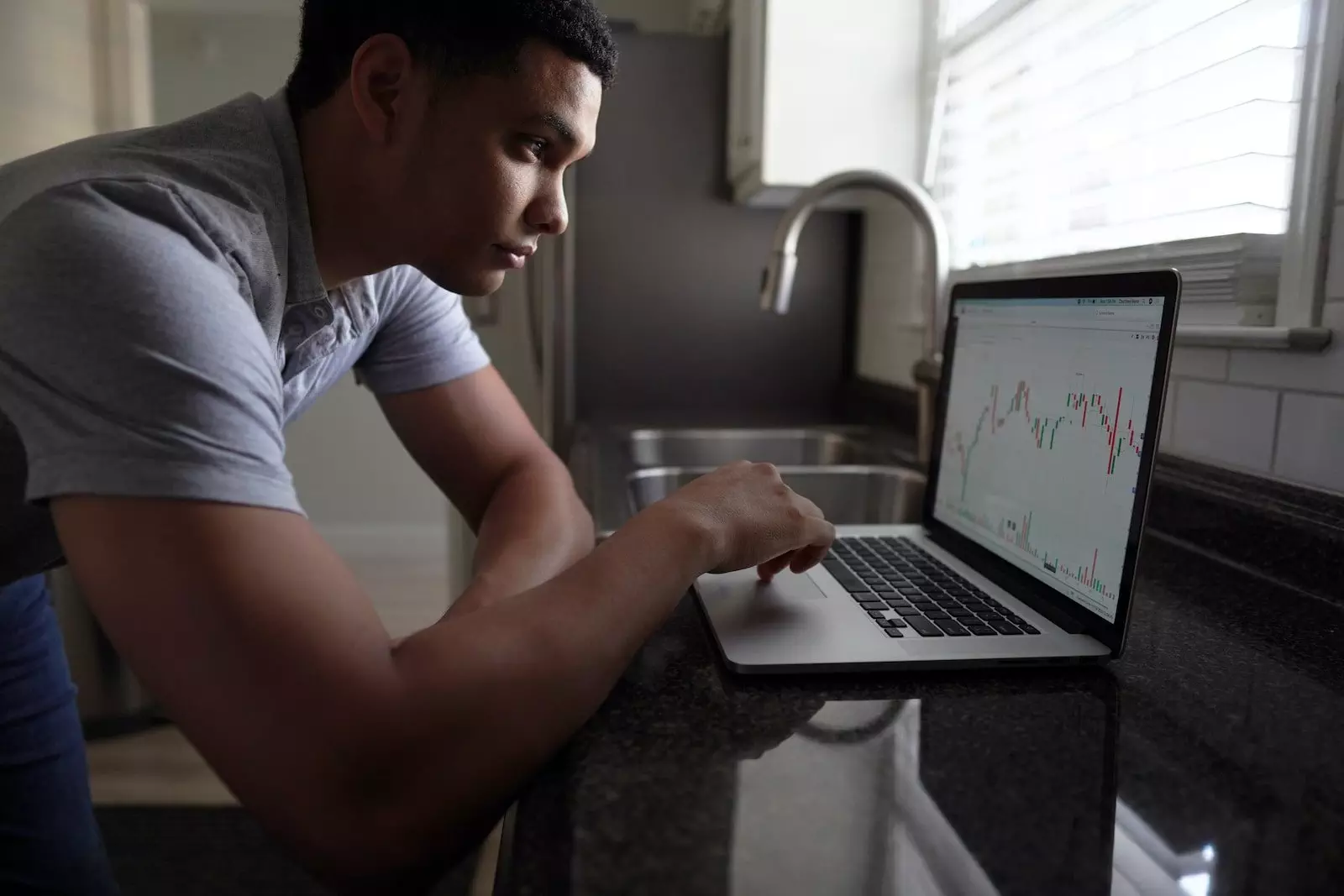 man in gray t-shirt using macbook pro; 7 Tips To Become A Better Investor! dividend investing; dividend snowball with REITs