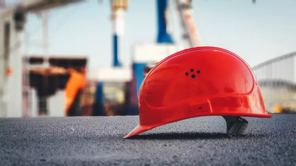 Red Hard Hat On Pavement; Dividend Safety